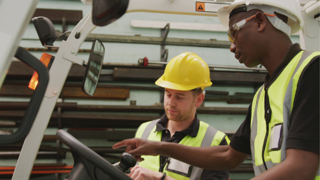 Warehouse associates reviewing WMS processes and equipment as part of incremental continuous improvement efforts focused on efficiency and stability.