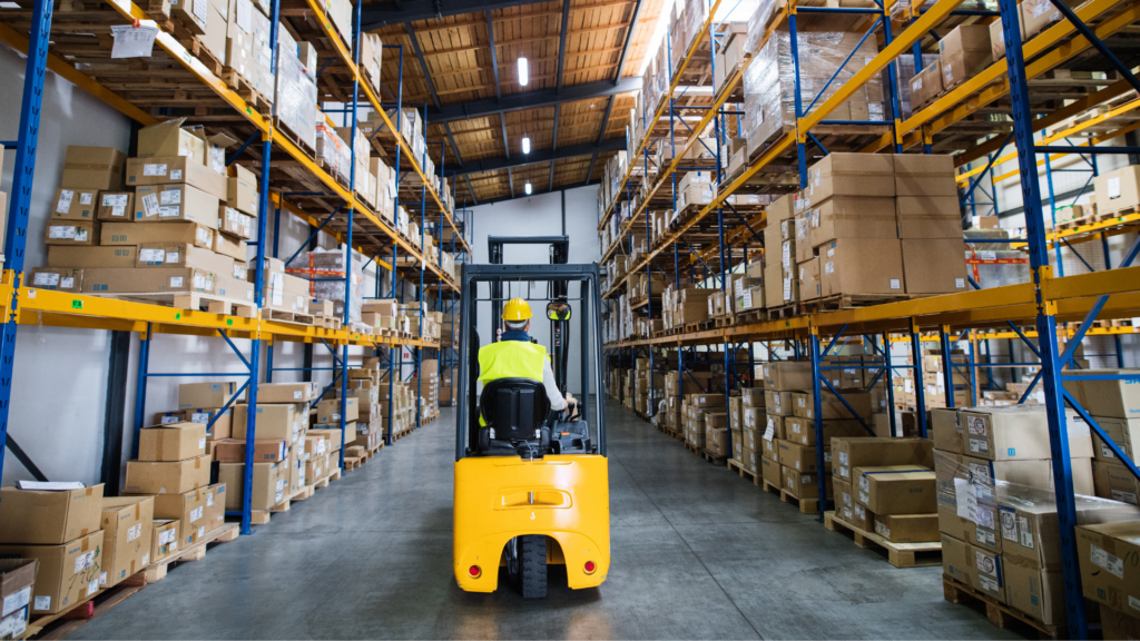 Forklift moving through warehouse aisles with inventory racking, illustrating warehouse operations and WMS implementation performance