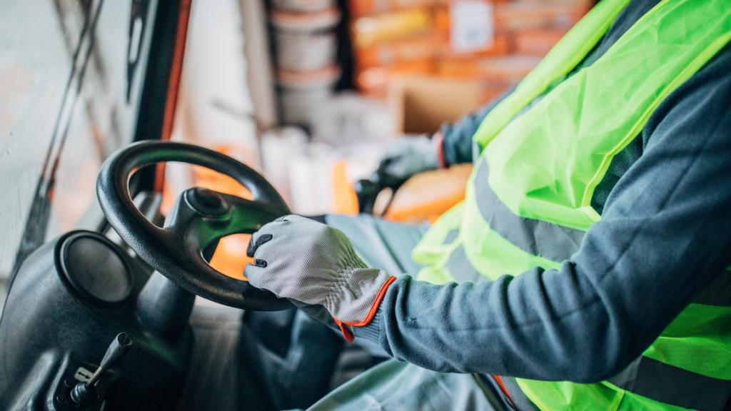 Warehouse worker operating forklift controls during WMS implementation, highlighting real-world warehouse operations and labor execution